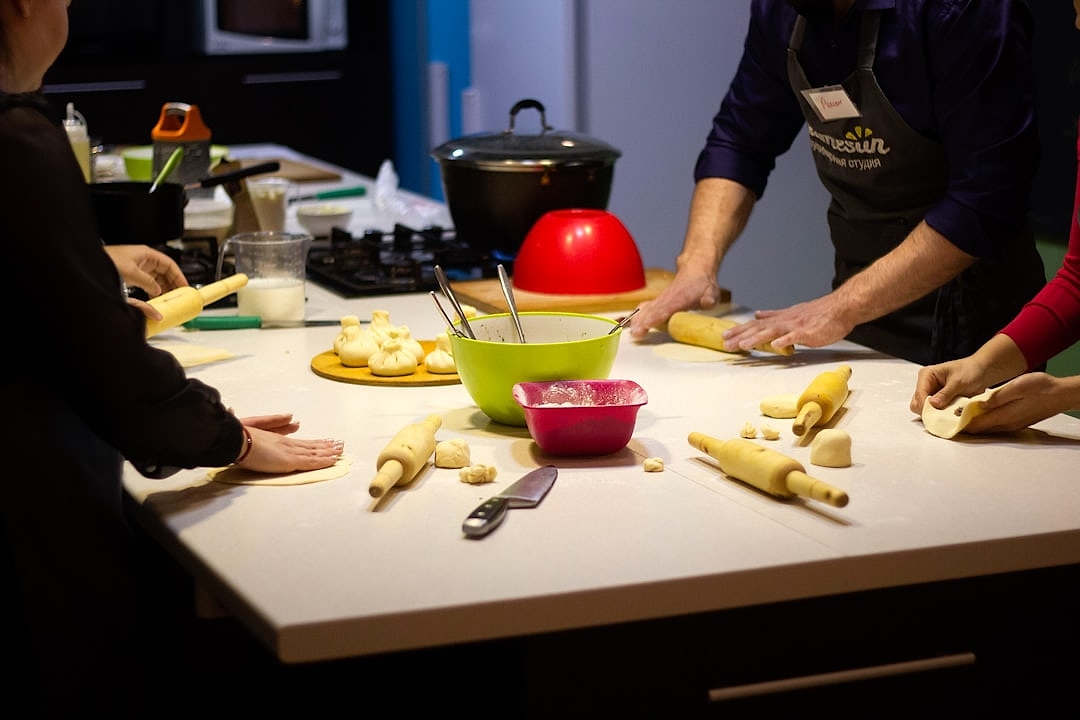Group cooking class in a community kitchen with fresh local ingredients